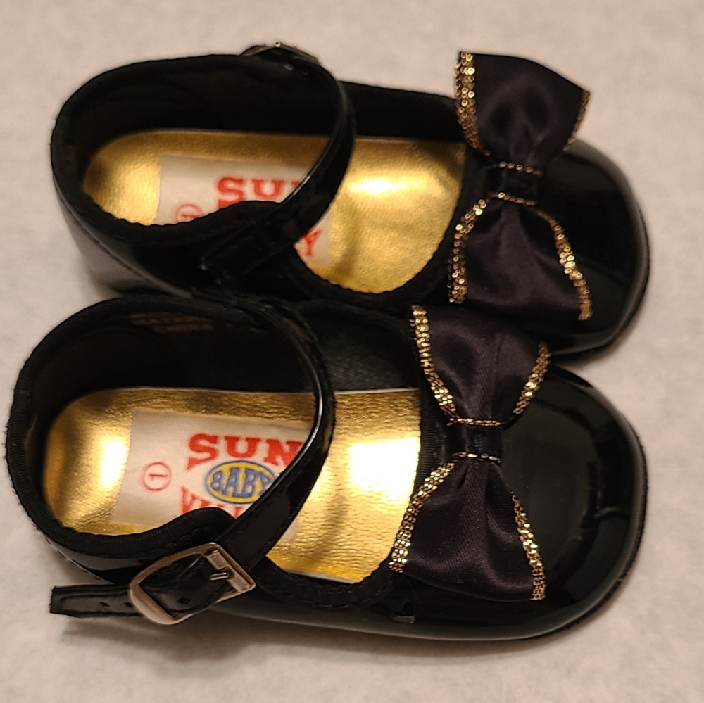 Black shiny Mary Jane style buckle shoes